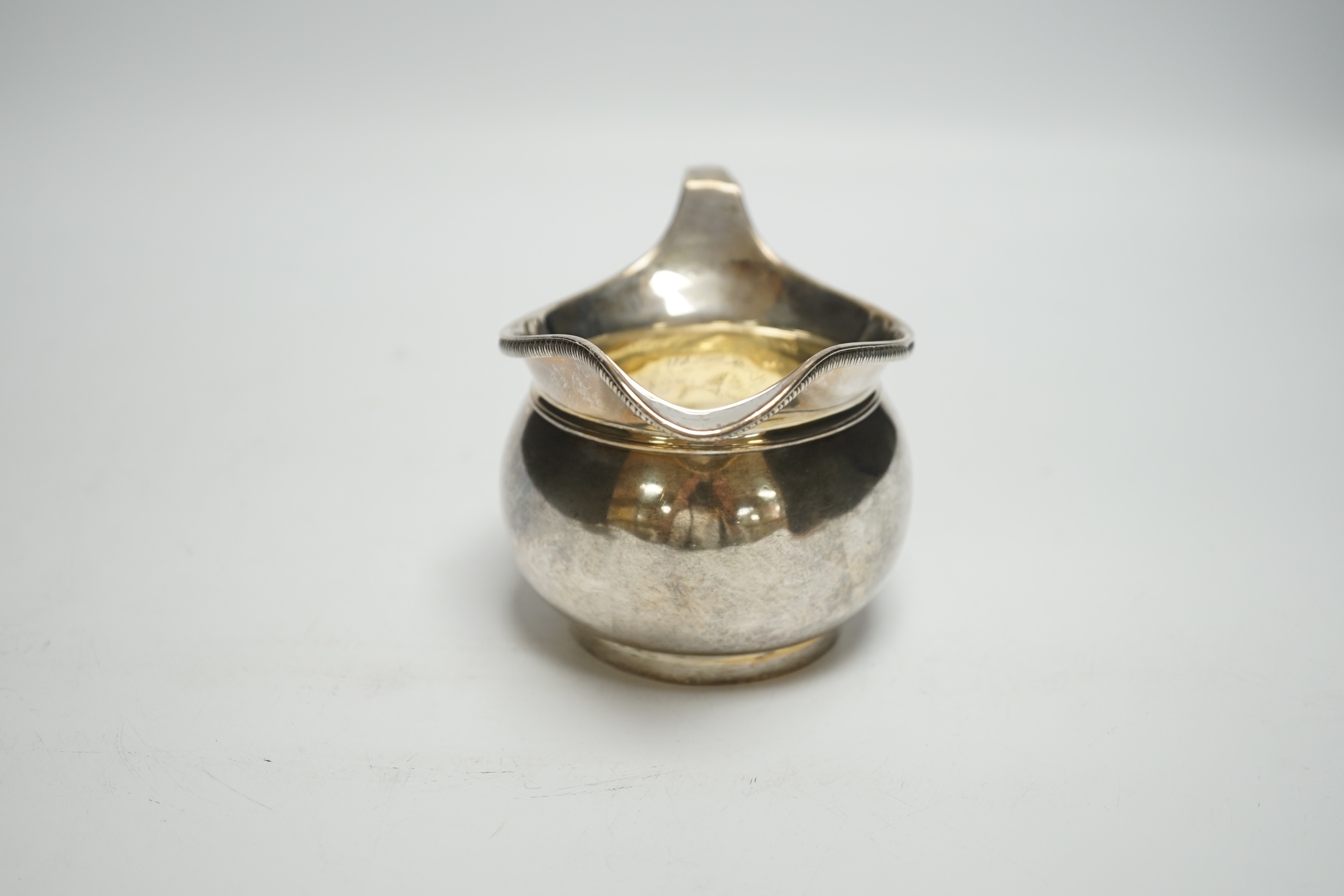 A George III silver cream jug, Richard Cook, London, 1802, 6.3oz.